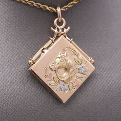 Antique Victorian Equestrian Horse Picture Locket in 14k Yellow Gold This exquisite locket sits with the point up and pens from the left side.  The original frames are still installed.The back is engraved with the initials RC.  The locket is crafted in 14k rosy yellow gold and also features rose and green gold applique' as well as white platinum flowers.  Perfect for the horse lover, this sentimental locket measures 15/16" across and top down.  Including the bail the piece measures 1 3/8".  The locket is not stamped but acid tests and weighs 5.67g. Gold Applique, Picture Locket, Antique Jewelry Necklace, Horse Pictures, Top Down, The Horse, Locket Necklace, Horse Lover, Antique Victorian