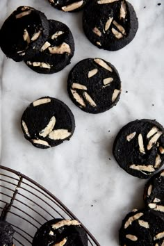 chocolate cookies with peanut butter frosting on a wire rack and white marble counter top