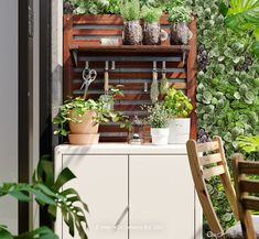 an outdoor garden area with potted plants and wooden shelves on the wall, next to a chair