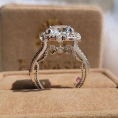 a diamond ring sitting on top of a box