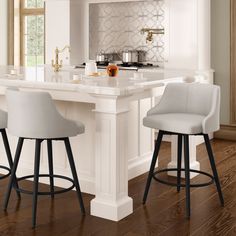 a kitchen island with three stools in front of it