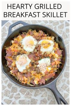 an iron skillet with eggs and ham in it, on top of a table