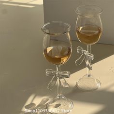 two wine glasses sitting next to each other