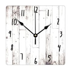 a clock that is on the side of a wooden wall in black and white colors