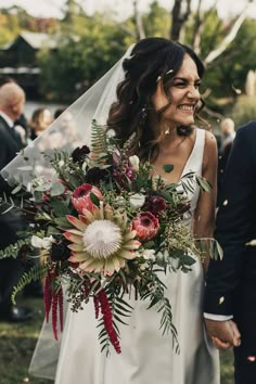 a bride and groom walking down the aisle