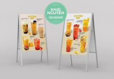 two menu boards with drinks on them next to each other