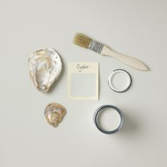 an assortment of items on a white surface including a brush, ring, and paper