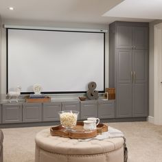 a living room filled with furniture and a flat screen tv mounted to the side of a wall