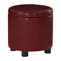 a red leather ottoman sitting on top of a wooden table