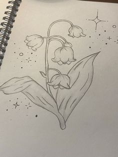 a drawing of a flower with stars in the background and a pen resting on top of it