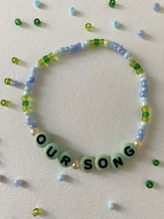 a beaded bracelet that says, our song