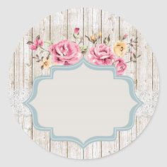 a round sticker with pink flowers and blue border on a white wooden plank background