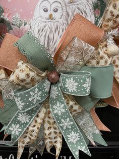 a christmas wreath with an owl and snowflakes on it