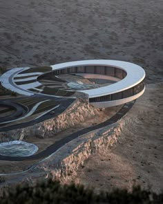 an aerial view of a circular building in the desert