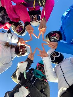 a group of people standing in a circle with their hands together