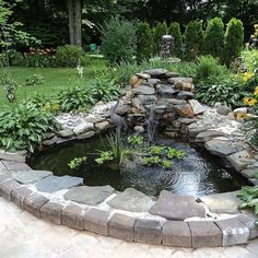 a small pond in the middle of a garden