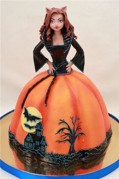 there is a cake that looks like a woman in a pumpkin costume