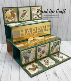 an open card box with some cards inside and the words happy written on it in gold foil