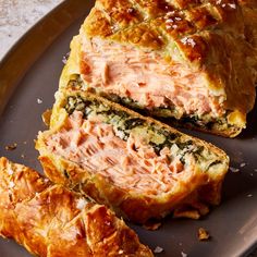 meatloaf with spinach and cheese on a plate next to croissants