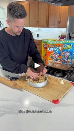 a man is making food in the kitchen with cereal and cereal bars on the counter