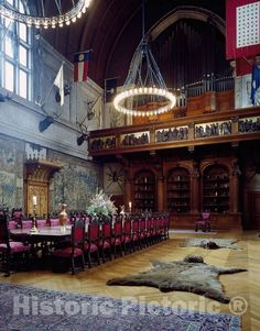 a large dining room with many tables and chairs in the center, along with an animal rug on the floor