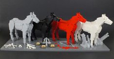 a group of lego horses standing next to each other