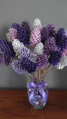 a vase filled with purple and white flowers