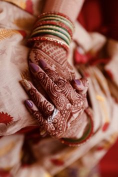 a woman's hands with hennap and bracelets