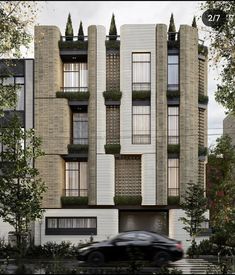 a car driving past a tall building with plants growing on it's windows and balconies