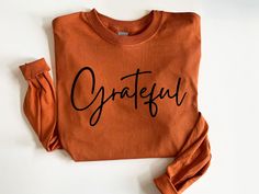 "Womens Thanksgiving Shirt, Grateful Shirt, Fall Shirt, Long Sleeve Fall Shirt, Thanksgiving Tee, Fall T shirt, Cute Fall Shirt, Thankful  HOW TO ORDER  1. Select the size and color of the shirt you would like to order. 2. Add the quantity of shirt(s) you would like and then click \"Add to Cart\" 3. Submit Order  4. During checkout please provide any additional information in the \"Note to Seller\" section. If you forget, just send me a message on Etsy after your order is completed.  GRATEFUL SH Thanks Giving Shirt Ideas, Cute Fall Shirts Vinyl, Thanksgiving Tshirt Designs, Thanksgiving Graphic Tees, Thanksgiving Cricut Shirts, Fall Christian Shirts, Fall T Shirt Ideas, Thanksgiving Shirts Vinyl, Fall Svg Shirts