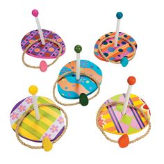 four colorful wooden toys on rope with dots and circles in the top one has two candles