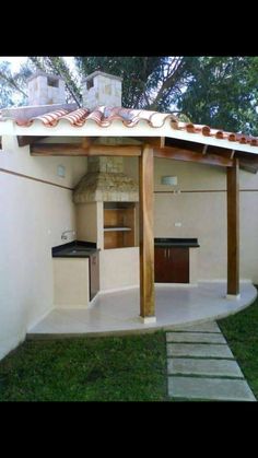 an outdoor kitchen is built into the side of a house