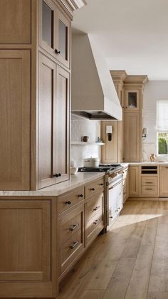 a large kitchen with wooden floors and cabinets