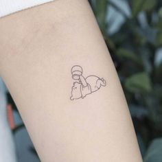 a small tattoo on the arm of a person with a cat and dog in it