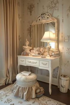 a white dressing table with a mirror, stool and lamp on it's side