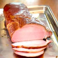 sliced ham sitting on top of a metal tray