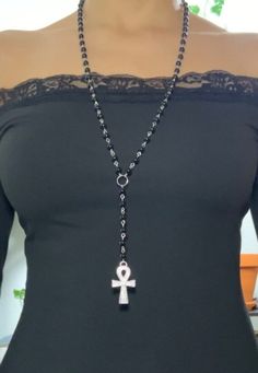 Long beaded ankh rosary with an ankh charm hanging on the back.  The larger ankh in the front is 1.5 inches long. The extra silver chain in the back including the charm- 3.8 inches total length- 22 inches  Website- elementalecstasy.org  Depop: elementalecstasy Instagram- elementalecstasy Spiritual Beaded Necklace, Rosary Necklace Outfit, Rosary Outfit, Ankh Belt, Ankh Rosary, Ankh Jewelry, Diy Rosary, Long Necklace Silver, Emo Jewelry