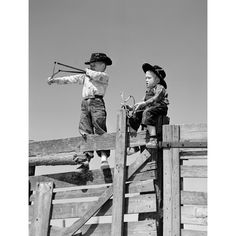 1950s Two Young Boys Dressed As Cowboys Shooting Slingshots On Top Of Wooden Fence Outdoor Print By Vintage Collection Image 1 Fence Outdoor, Helicopter Parent, Wooden Fence, Mom Kid, Fine Arts Posters, Vintage Images, Vintage Collection, Posters Art Prints, Fence