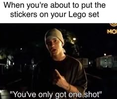 a man standing in the dark with his hand up and pointing at something that reads, when you're about to put the stickers on your lego set you've only got one shot