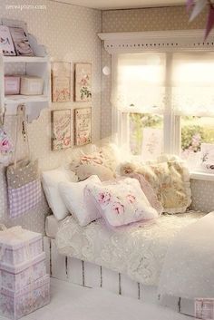 a doll house bedroom with white bedding and pink accessories on the windows sill