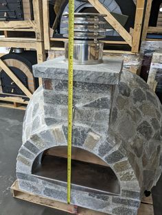 a stone oven with a measuring tape around it