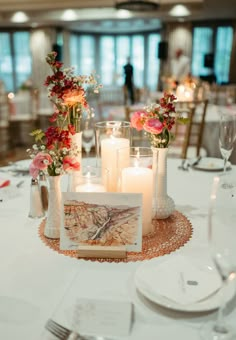 the table is set with candles and flowers