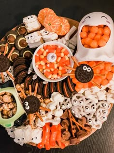 an assortment of halloween treats on a platter with candy and candies in the shape of eyes