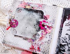 an altered book with pink and white flowers on the pages is laying on a lace doily