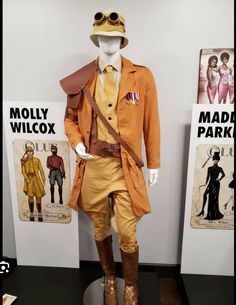 a mannequin dressed in an orange suit and hat with sunglasses on his head