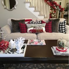 a living room filled with lots of furniture and christmas decorations on top of a coffee table