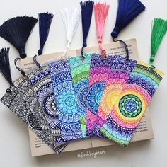 several different colored tassels on top of an open book