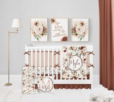 a baby's nursery room with flowers and monogrammed wall art