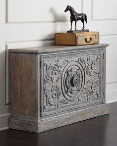 an old trunk with a horse figurine on top