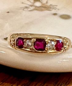 Antique 18k yellow gold ring set with three round cut rubies alternating with two old cut diamonds. Full British hallmarks for Chester, year 1898, and 18k gold. British ring size R, U.S. ring size 8.75. A nice substantial size at total weight 3.7g. Band is 1/4 inch wide in the front and narrows to 1/8 inch in back. The rubies are a gorgeous deep red color and the two old cut diamonds have a nice bright sparkle. In very good antique condition and the band is comfortable to wear and stack. U.S. do Ruby Bands, Ruby And Diamond Ring, S Ring, Deep Red Color, Gold Ring Sets, 18k Yellow Gold Ring, Yellow Gold Ring, Multi Stone Ring, Multi Stone